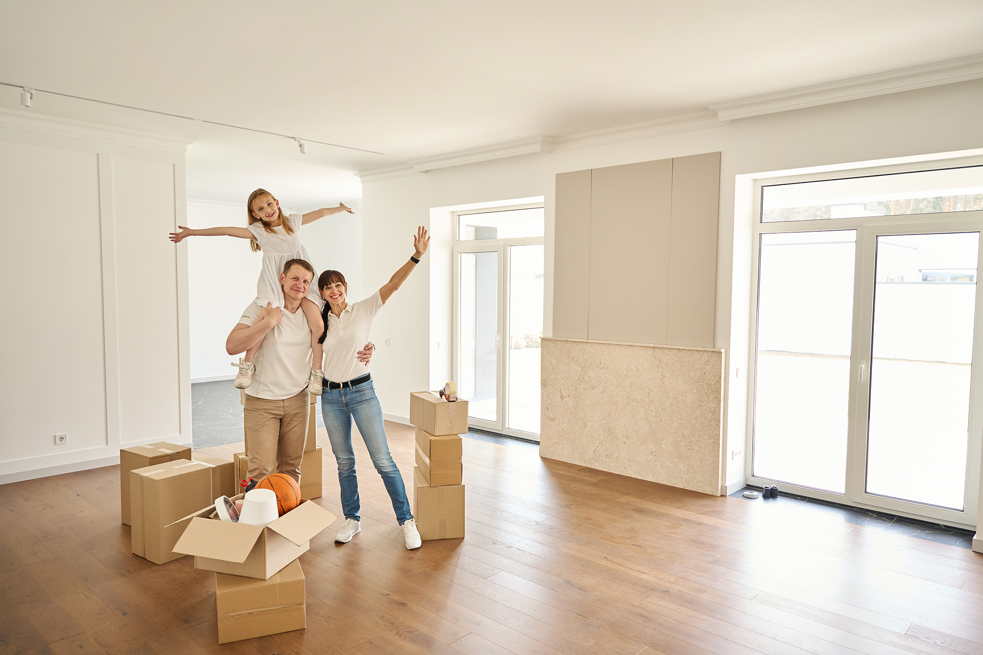 Happy,parents,with,child,in,middle,of,spacious,empty,room